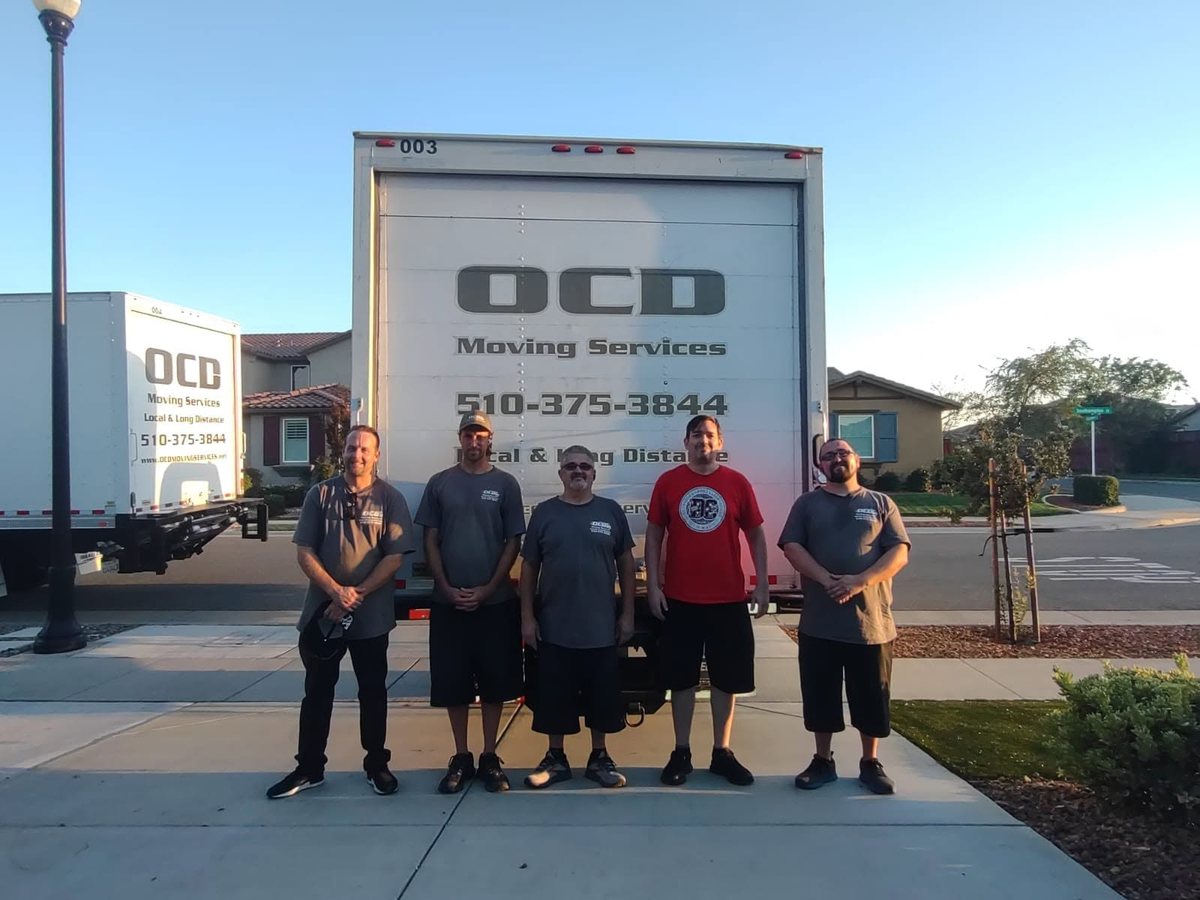 OCD Moving Services crew with their branded moving truck