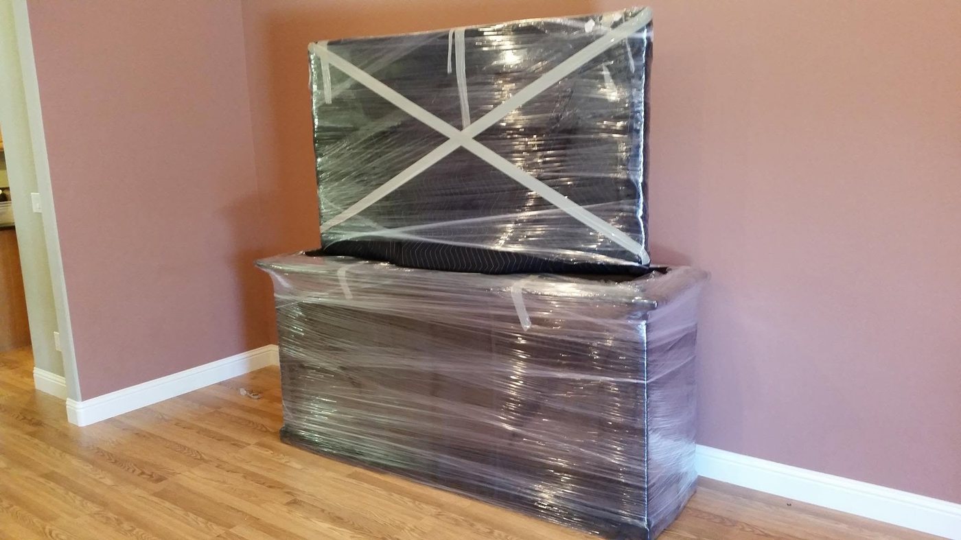 OCD Moving Services shrink-wrapped and cross-taped a flat-screen TV and media cabinet to protect them during the move