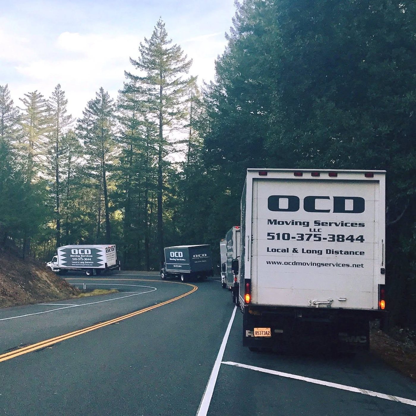OCD Moving Services trucks on a California road during a long-distance move